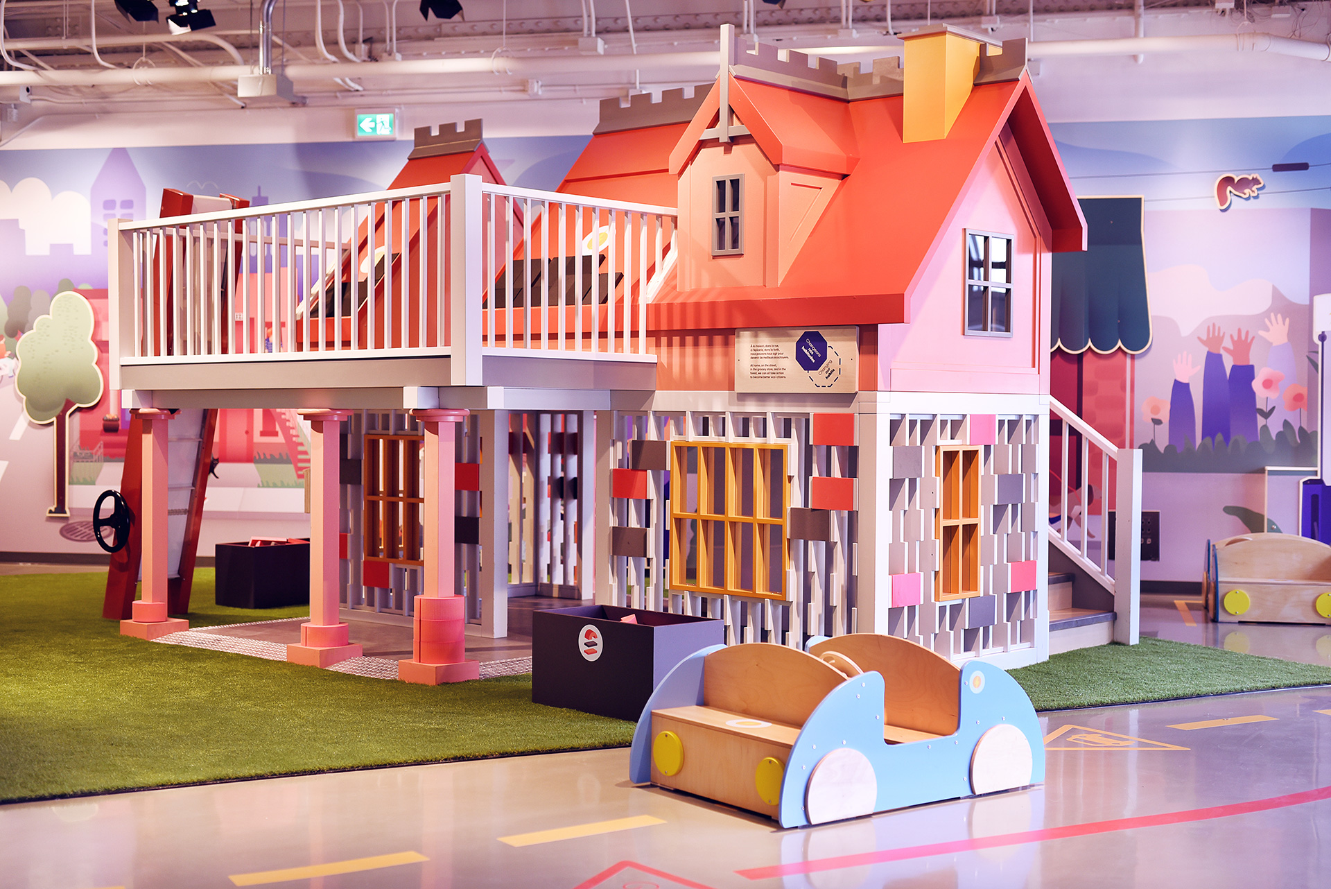 A playhouse and toy car inside the Mini Mondo exhibition
