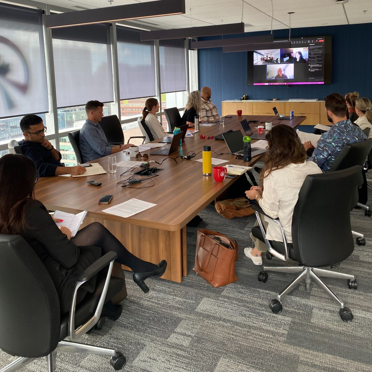 People sitting around a boardroom table during a meeting