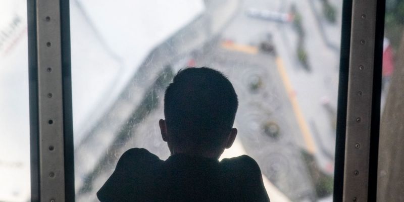 Child peering through the Glass Floor at the CN Tower