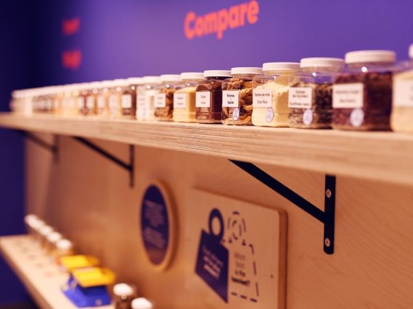 A diverse range of spices sits on a shelf at the Mini Mondo exhibition