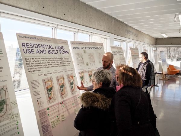 Group of people reviewing presentation boards