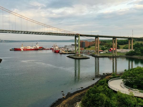 Views of a harbourfront, a bridge and ships